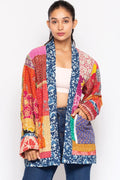 Model wearing the colorful reversible Kantha quilted sari jacket, front view