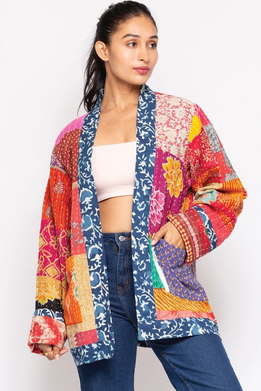 Model wearing the reversible Kantha jacket with hand in patch pocket