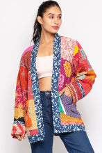 Model wearing the reversible Kantha jacket with hand in patch pocket