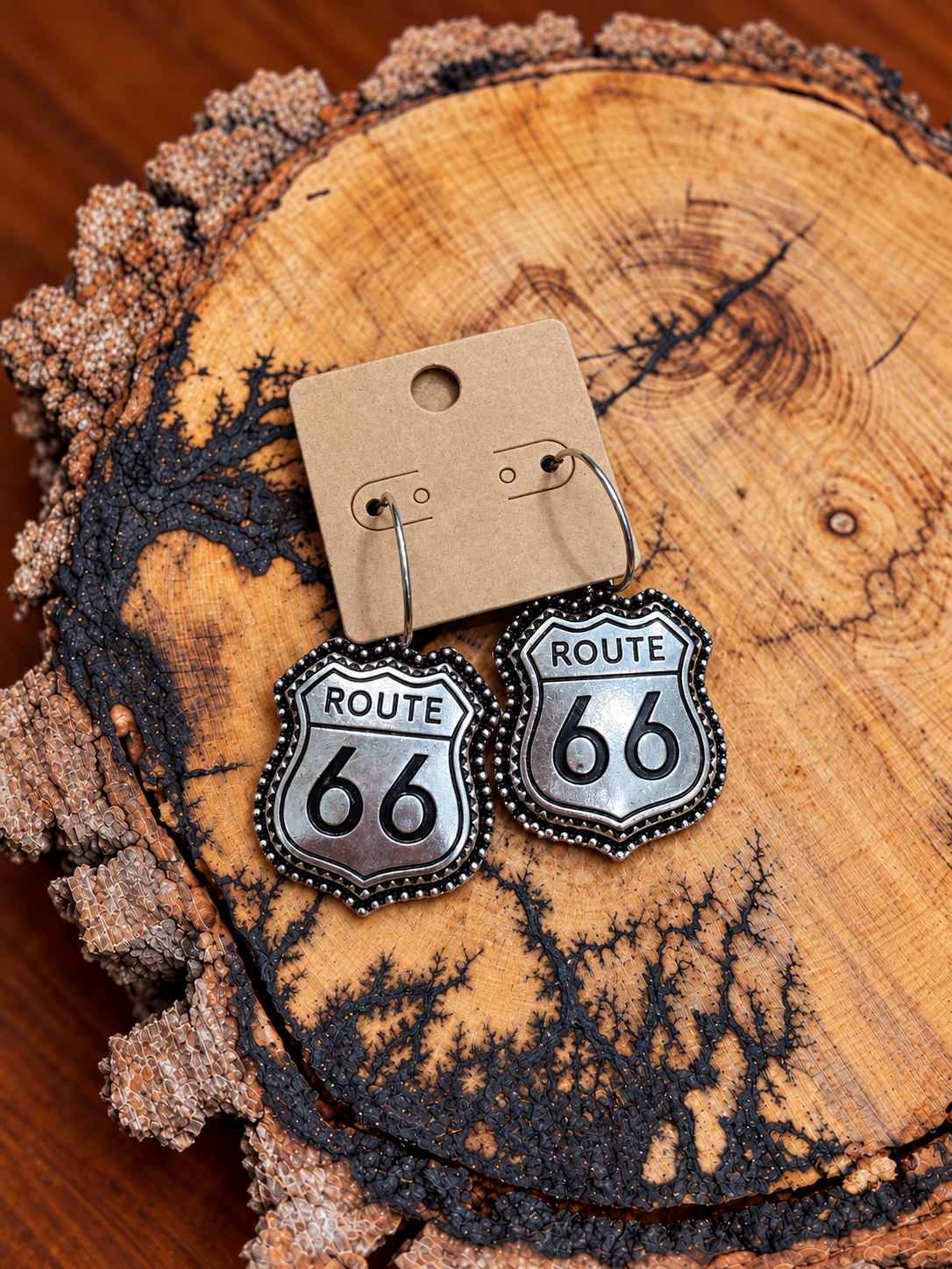 Route 66 earrings on warm wood