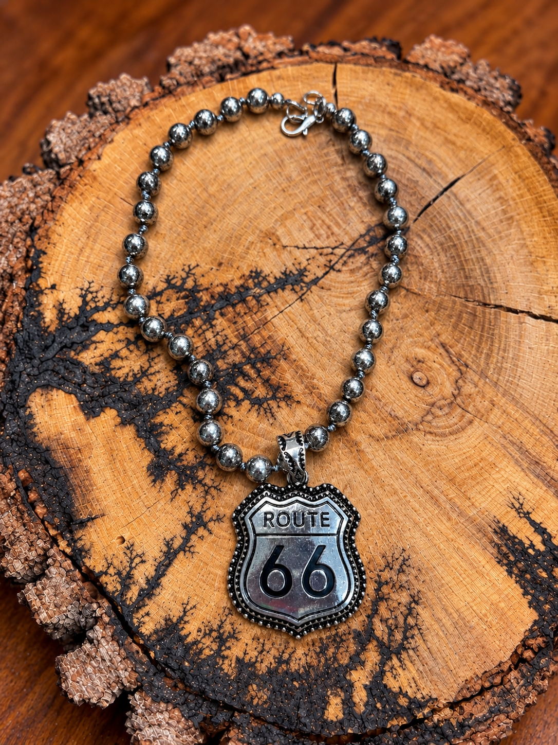 Route 66 necklace on warm wood