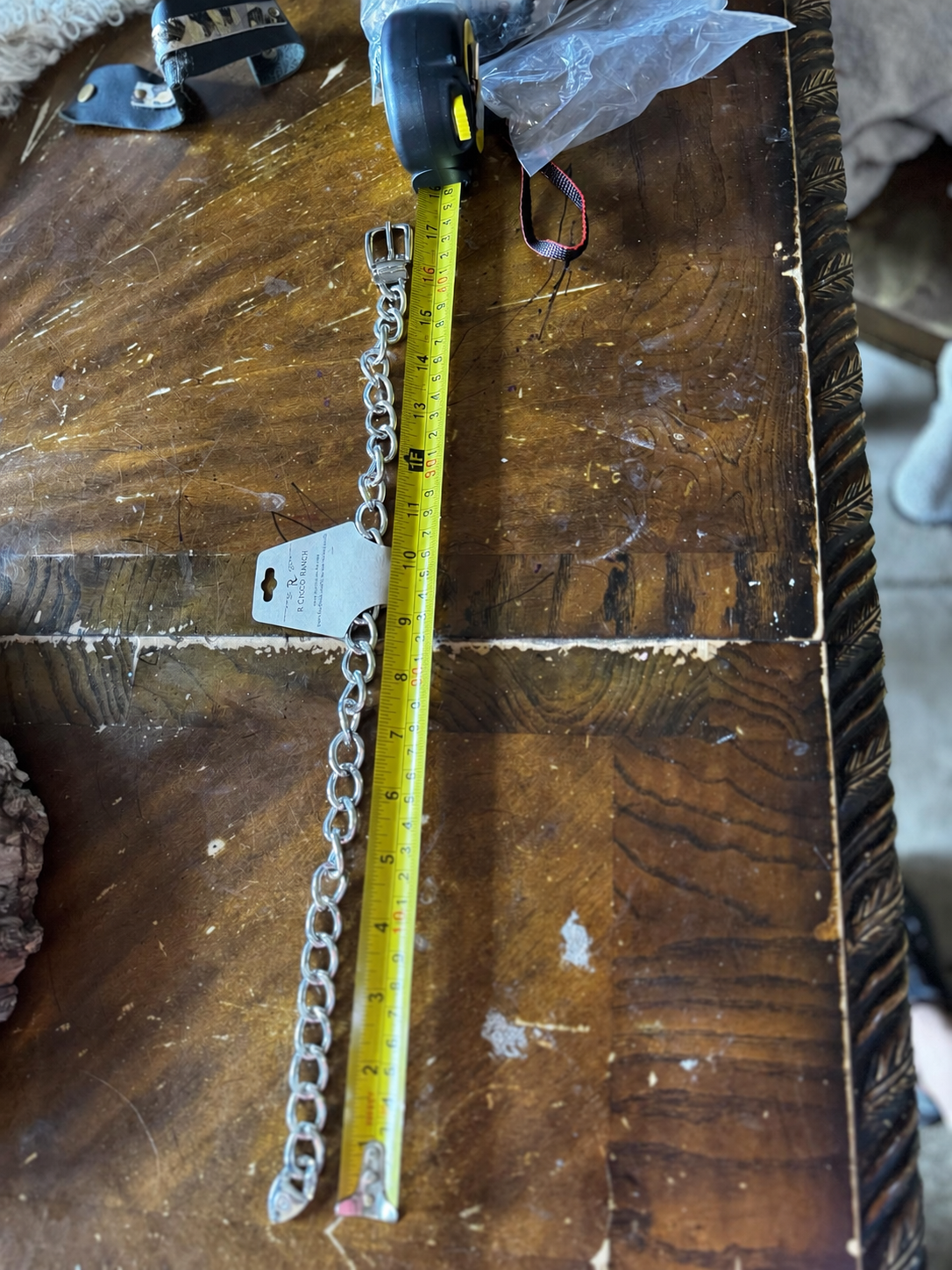 Silver-tone chunky chain necklace shown beside measuring tape