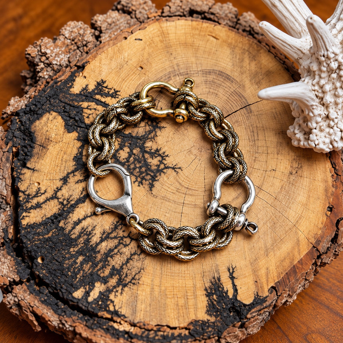 Snaffle bit chain bracelet with silver-tone clasp and mixed gold-tone and silver-tone accents on rustic wood