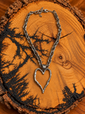 Silver-Tone Open Heart Chain Necklace on rustic wood
