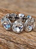 Silver-tone round clear crystal stretch bracelet on rustic wood