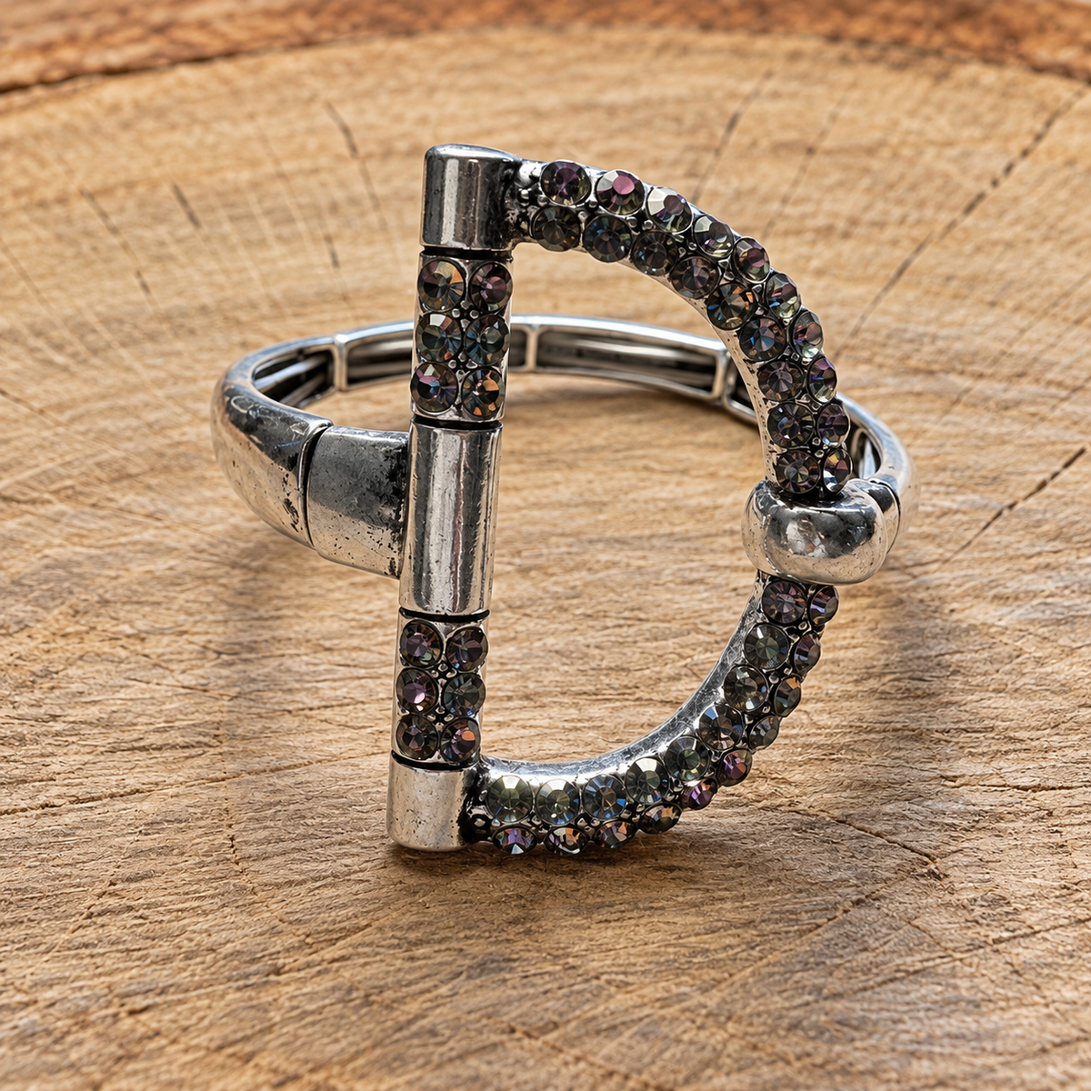 Silver-tone snaffle bit rhinestone bracelet on natural wood