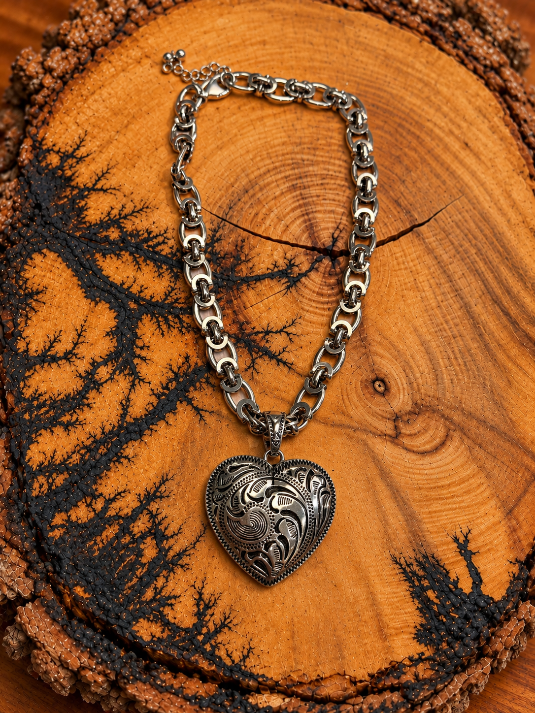 Silver-Tone Western Scroll Heart Necklace on rustic wood