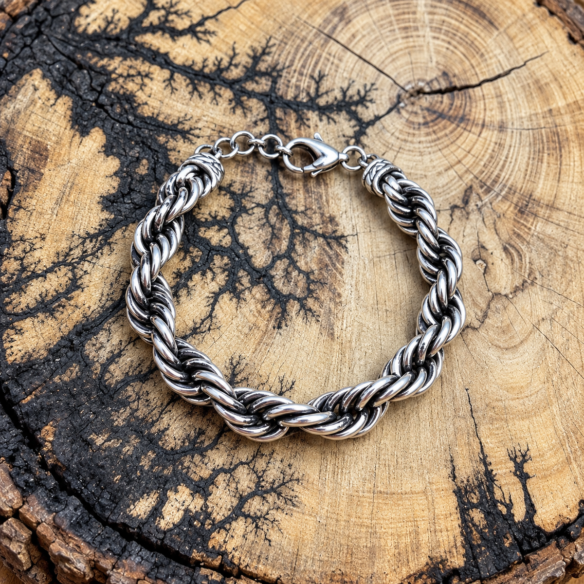 silver-tone twisted rope chain bracelet on rustic wood