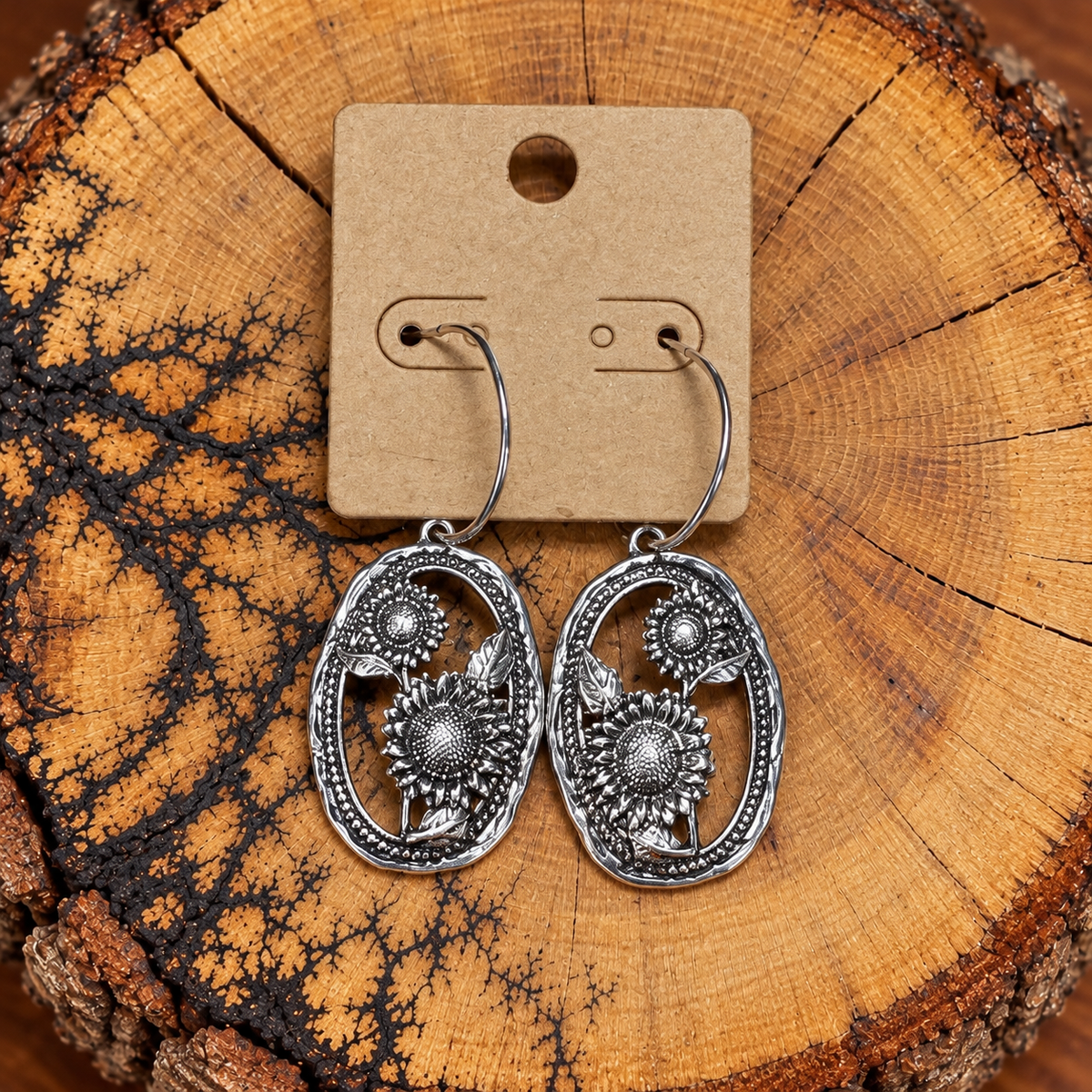 Silver-Tone Sunflower Oval Hoop Earrings on a plain kraft card