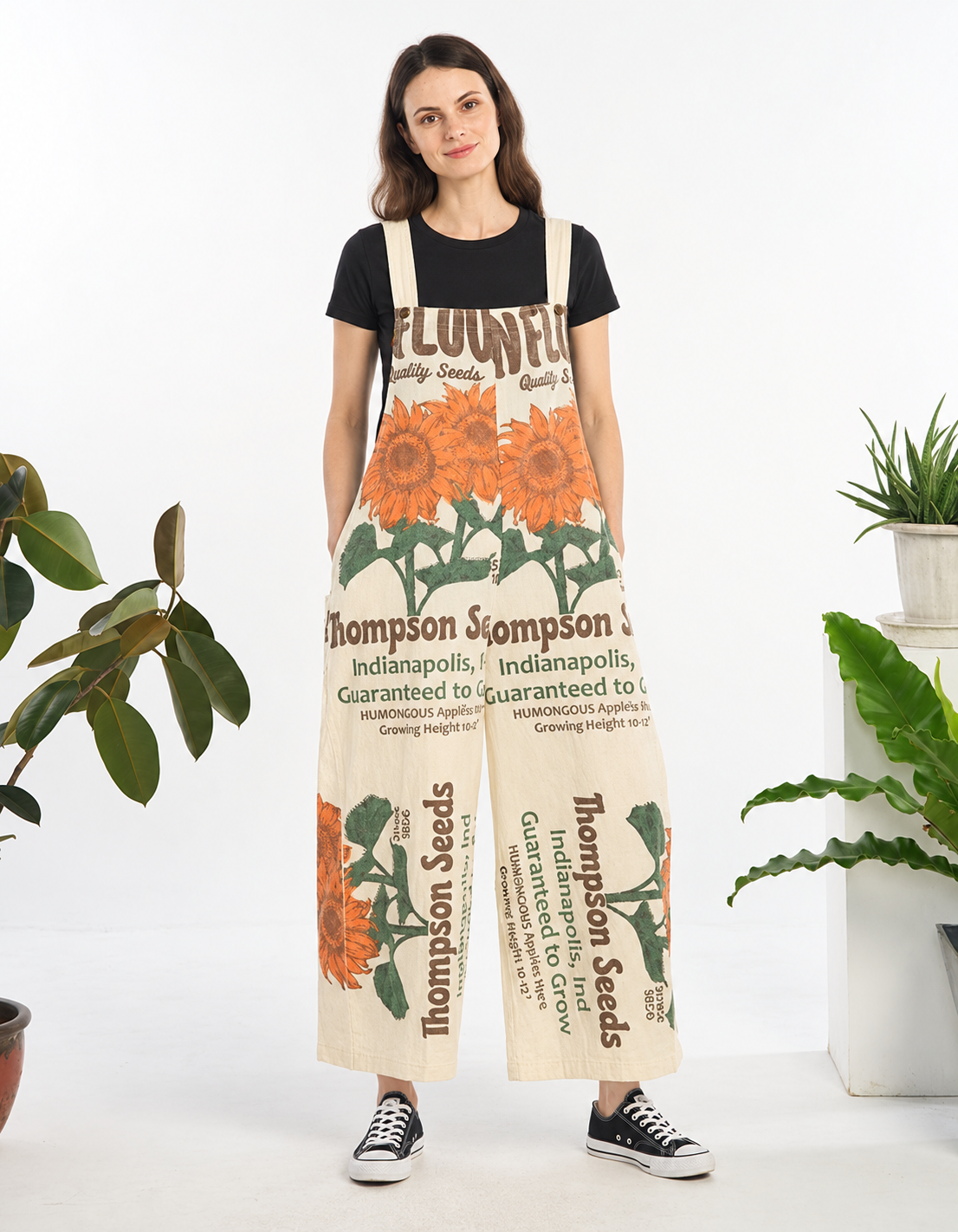 Model wearing the Sunflower Thompson Seeds vintage feed sack wide-leg jumpsuit with a black tee and black sneakers