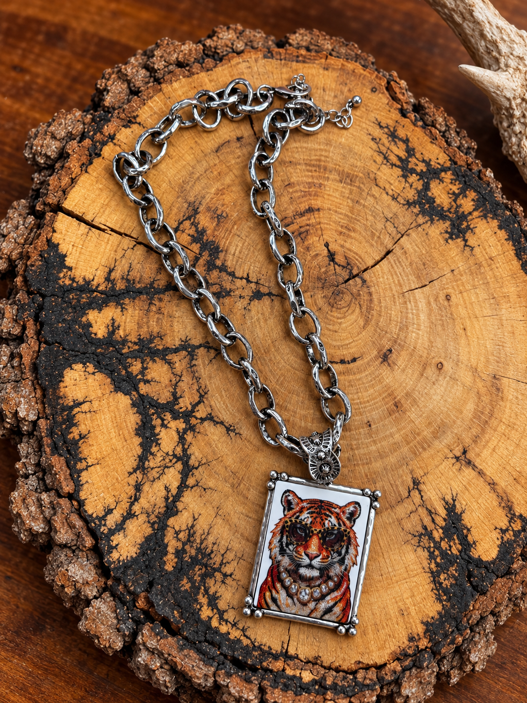 Tiger in sunglasses rectangular pendant necklace with silver-tone oval-link chain on rustic wood