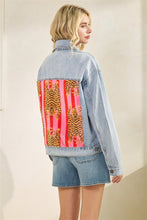 Angled back view of Tiger Queen velour patch denim jacket