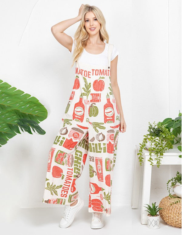 Model wearing the Tomato vintage feed sack wide-leg jumpsuit over a white tee with white sneakers