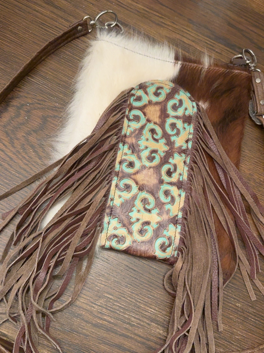 One-of-a-kind purse with brown and white panels, turquoise scrollwork and long brown fringe