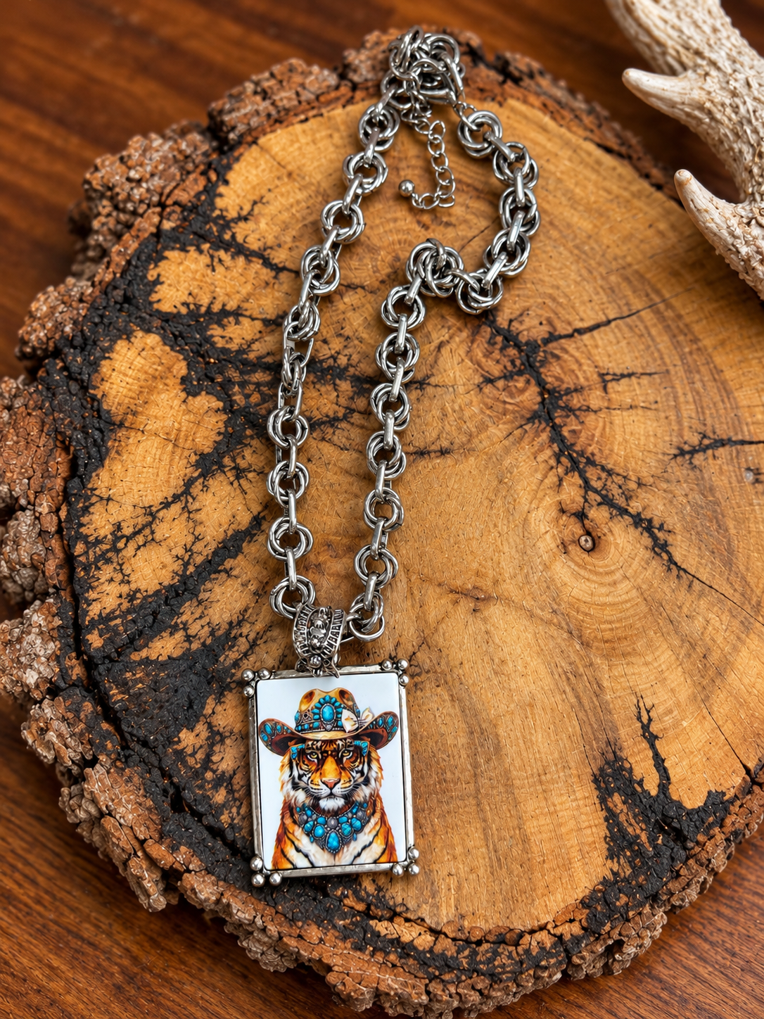 Western tiger portrait pendant necklace with silver-tone double-ring chain on rustic wood