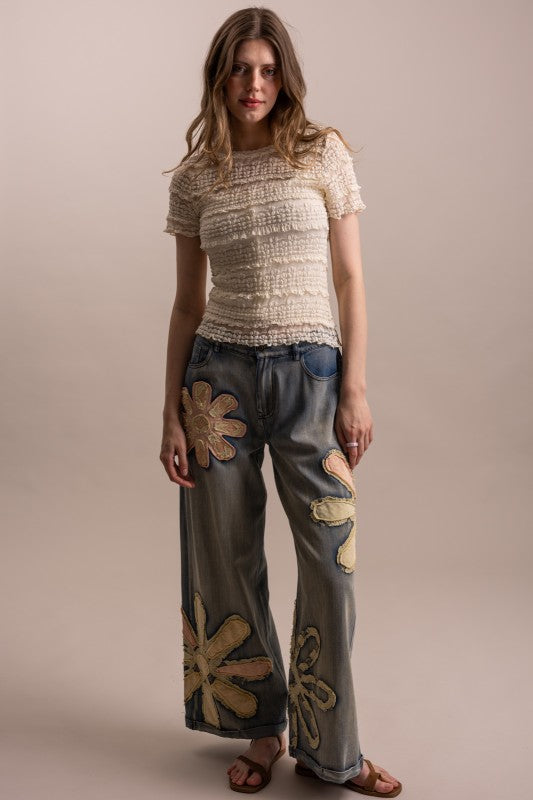 Wildflower patchwork wide-leg denim pants styled full-length front view