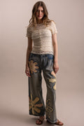 Wildflower patchwork wide-leg denim pants styled full-length front view