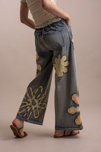 Wildflower patchwork wide-leg denim pants angled back view