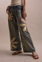 Wildflower patchwork wide-leg denim pants angled front view